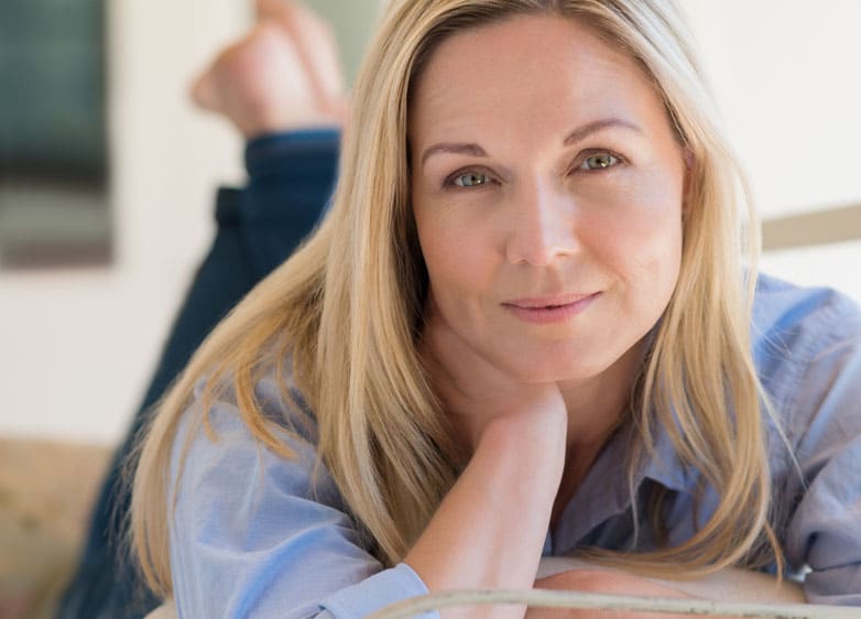 Woman lying on her stomach smiling