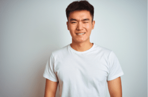 asian chinese man wearing winking looking at the camera