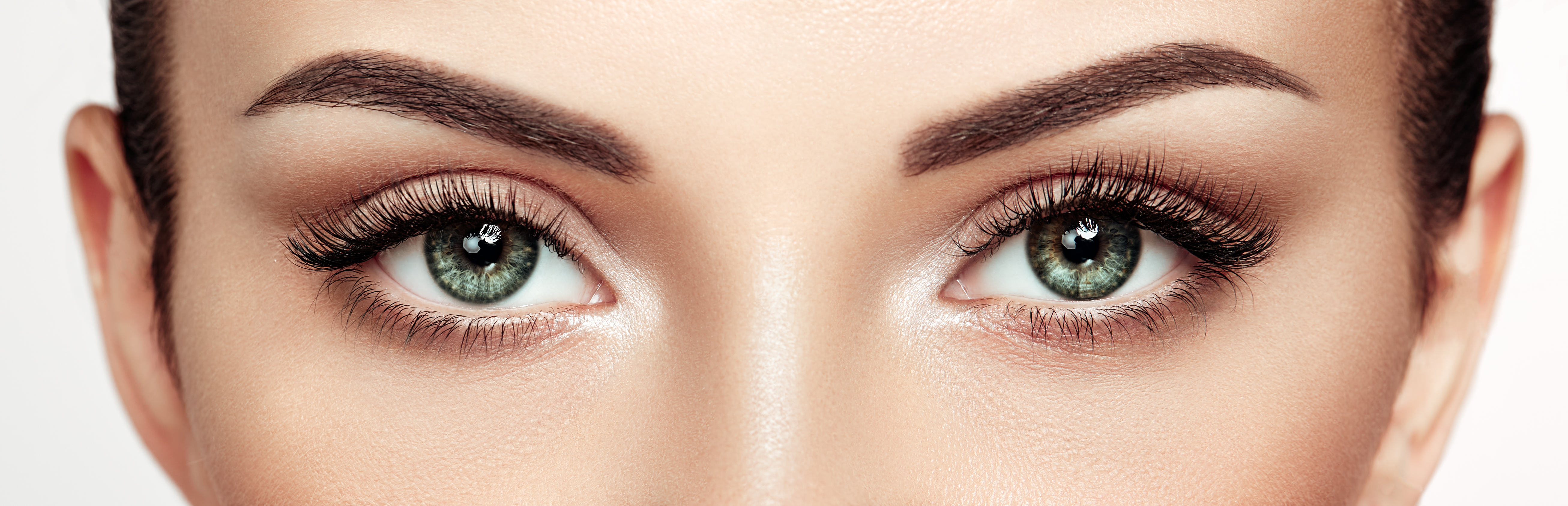 Close up of beautiful woman’s eyes showing smooth skin, elevated eyebrows, and eyelids without significant sagging.