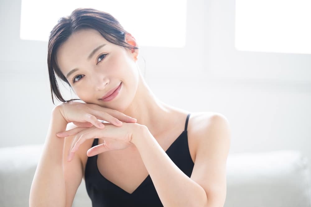 An Asian woman smiling at the camera